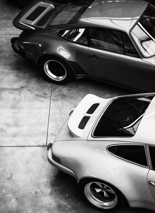 Classic Porsche 911 Duo Black & White Poster Print – Vintage 911 Wall Art with Whale-Tail Spoilers, High-Angle Garage Shot